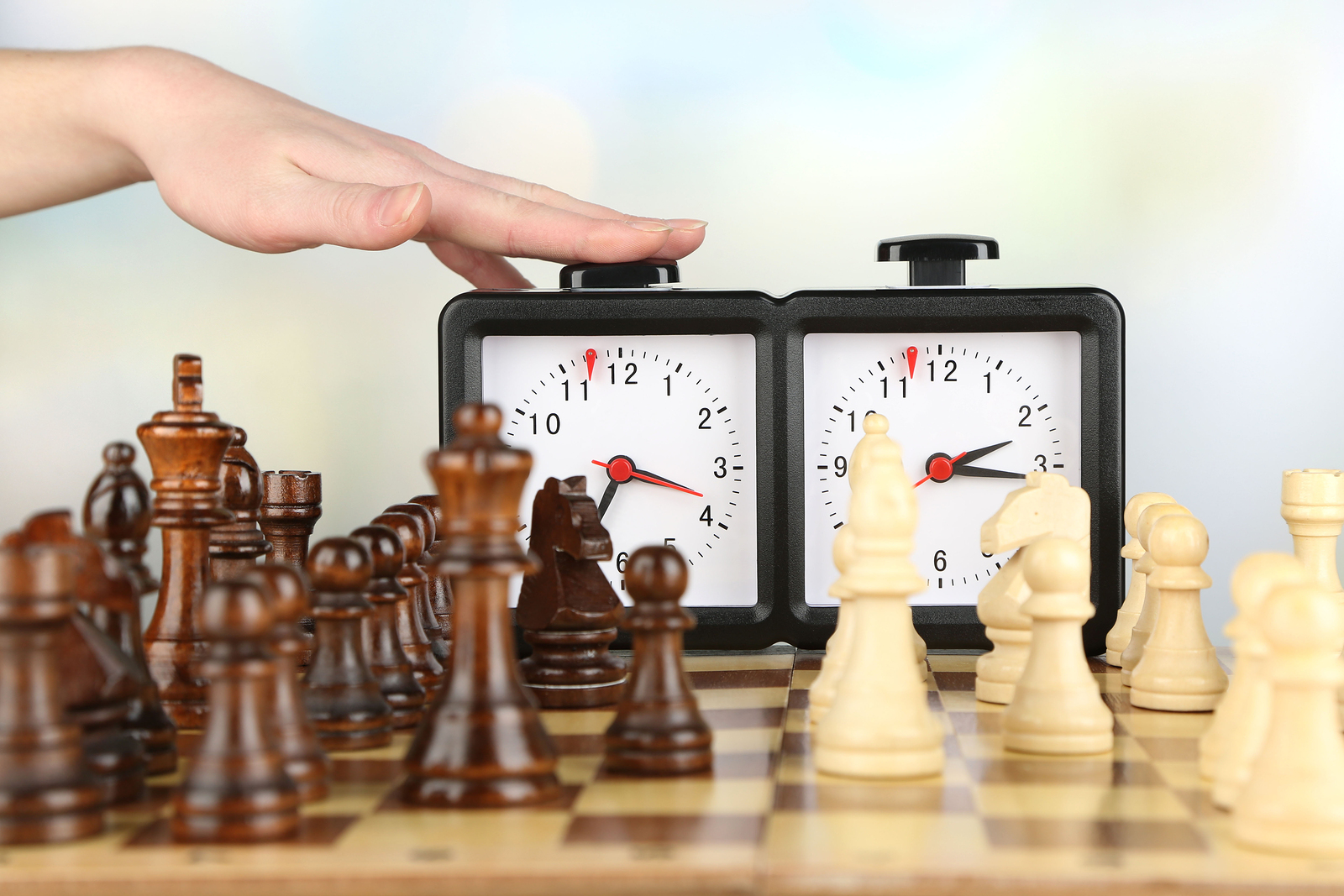 Grown men play chess using a watch to control time